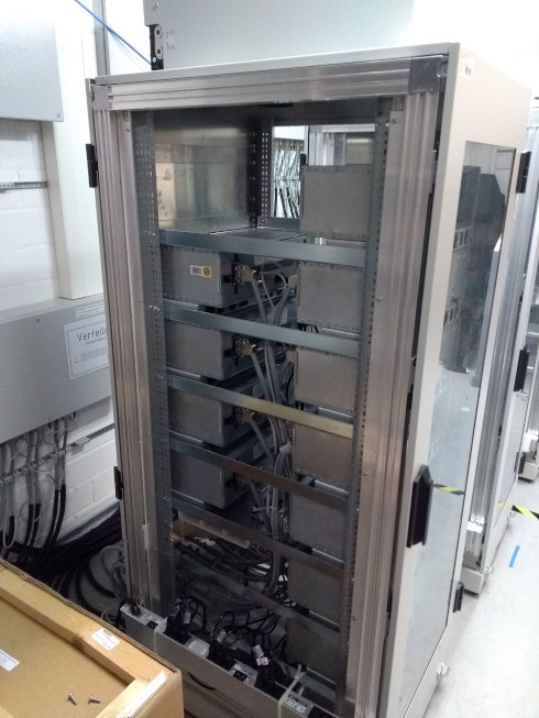 A DC supply rack with ~20 linear power supplies.